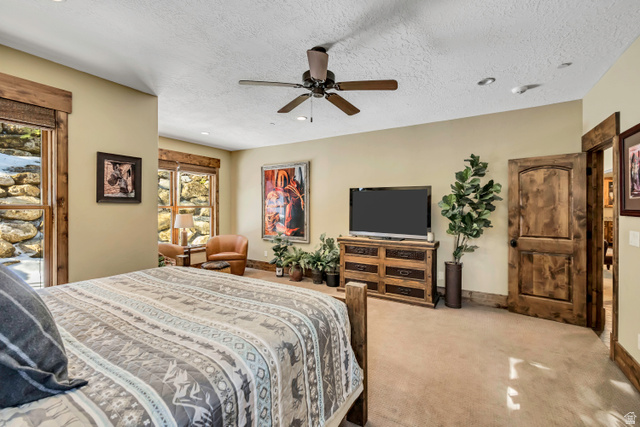 9049 Timphaven Road Sundance, UT 84604 - Photo 29 of 63 Bedroom with light colored carpet, ceiling fan, a textured ceiling, and recessed lighting
