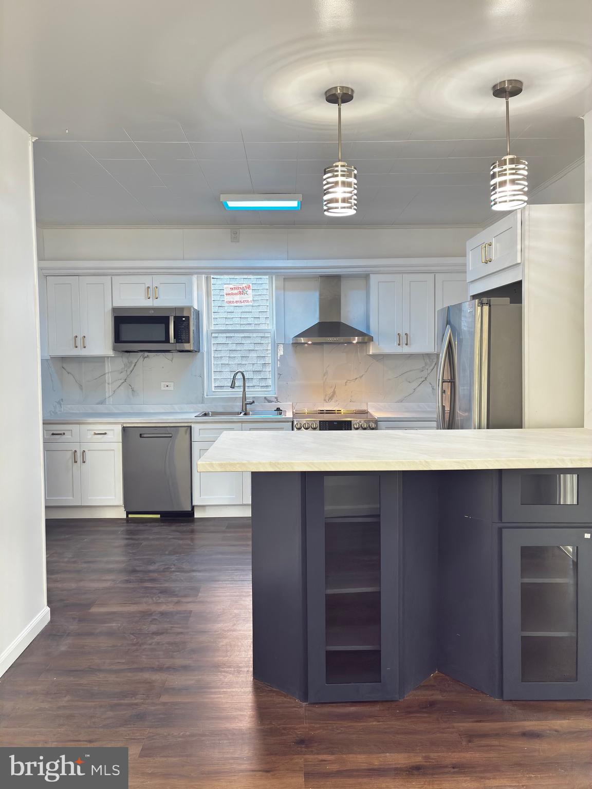 41 South 2nd Street Steelton, PA 17113 - Photo 14 of 24 a kitchen with kitchen island granite countertop a sink cabinets and stainless steel appliances