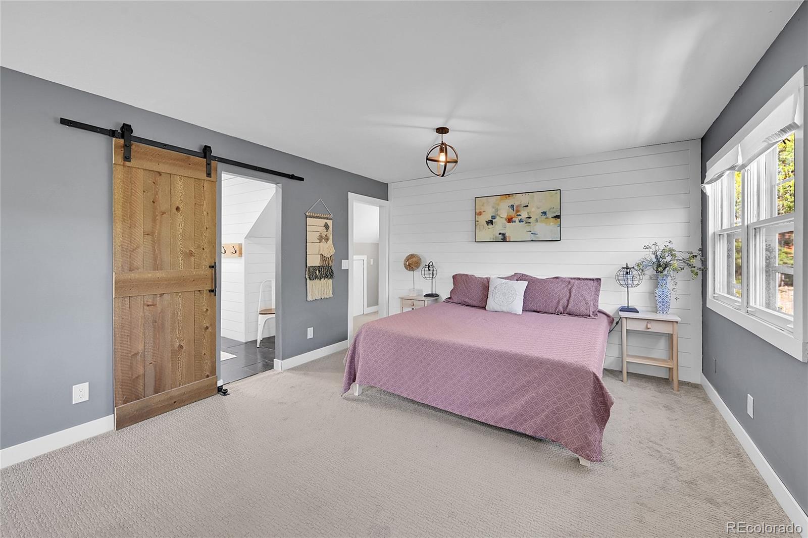 9092 South Gray Lane Conifer, CO 80433 - Photo 11 of 23 a spacious bedroom with a bed and a window