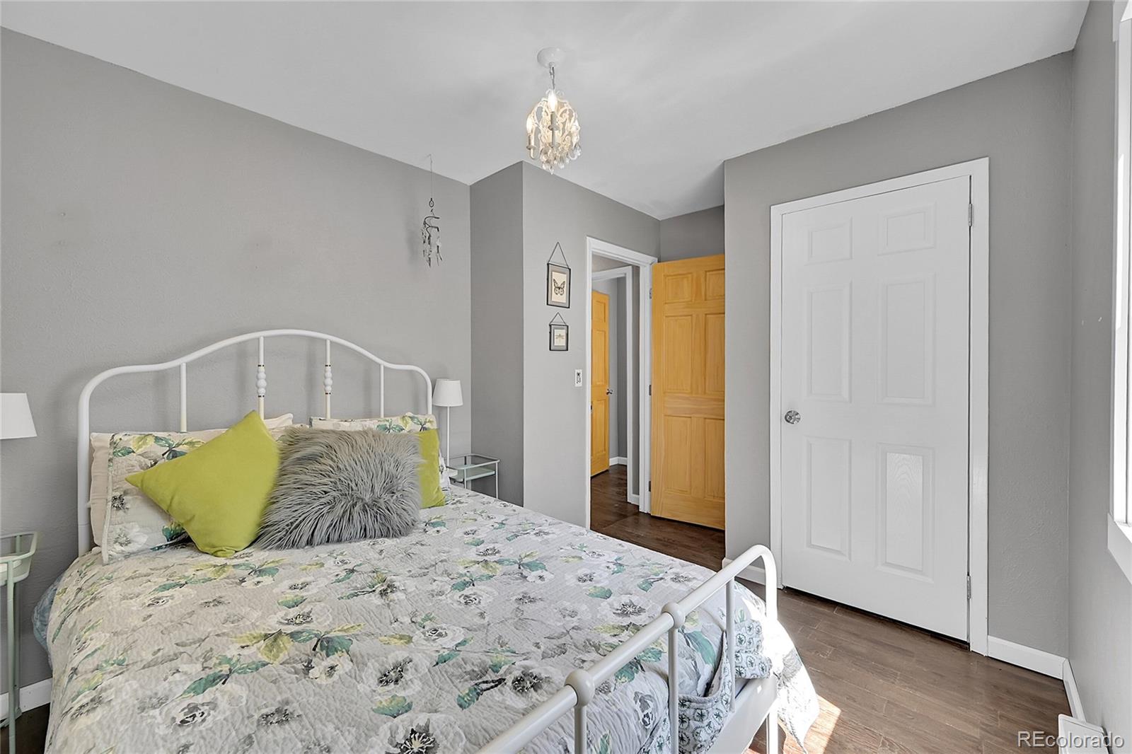 9092 South Gray Lane Conifer, CO 80433 - Photo 13 of 23 a bedroom with a bed and wooden floor
