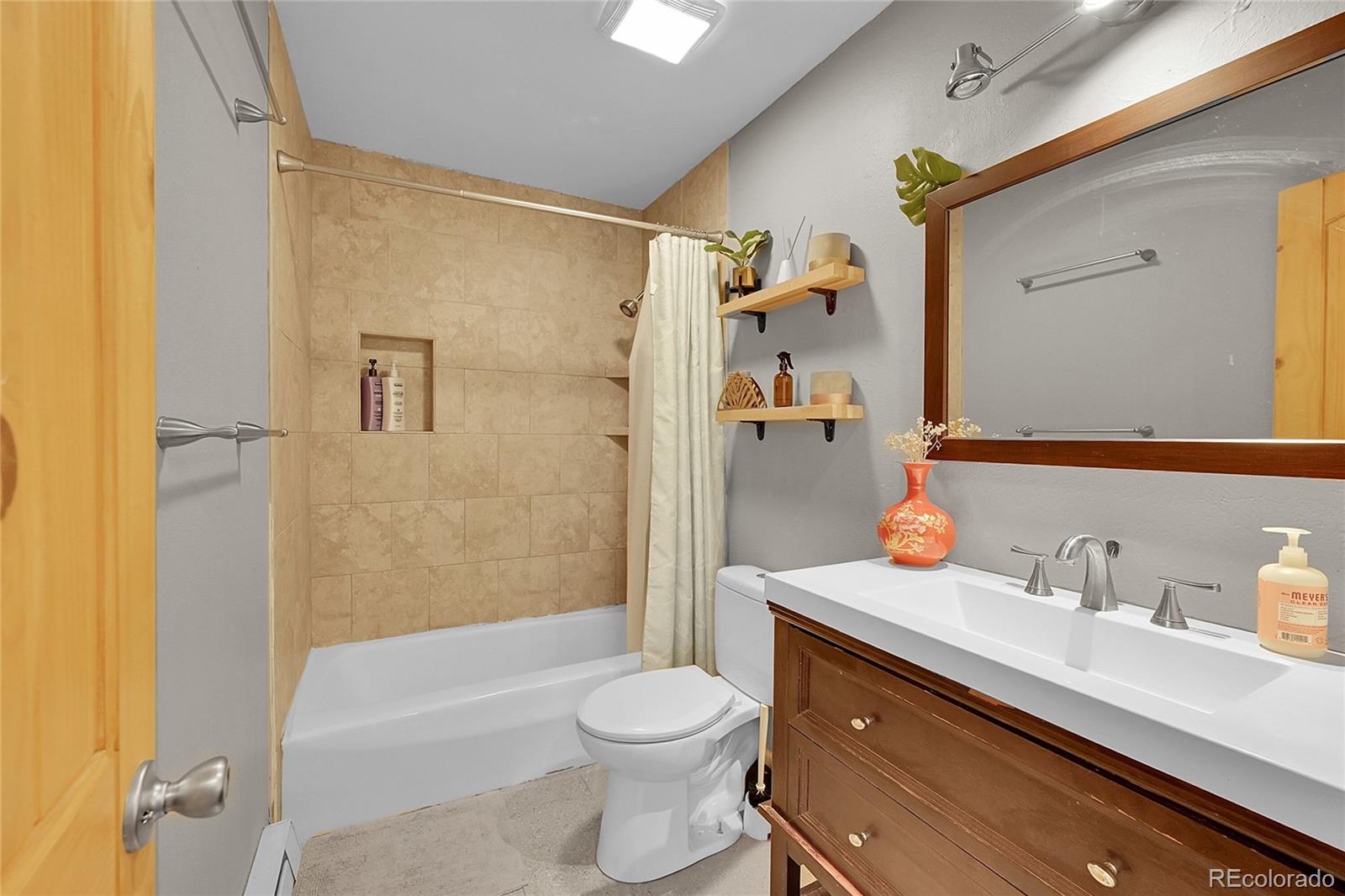 9092 South Gray Lane Conifer, CO 80433 - Photo 16 of 23 a bathroom with a sink a toilet and shower