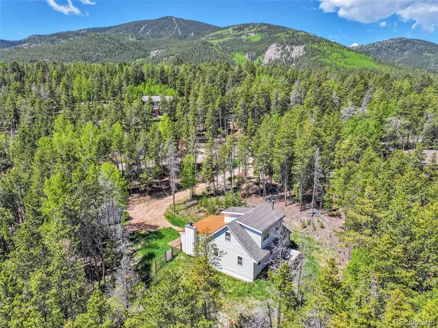 an aerial view of a house with a yard