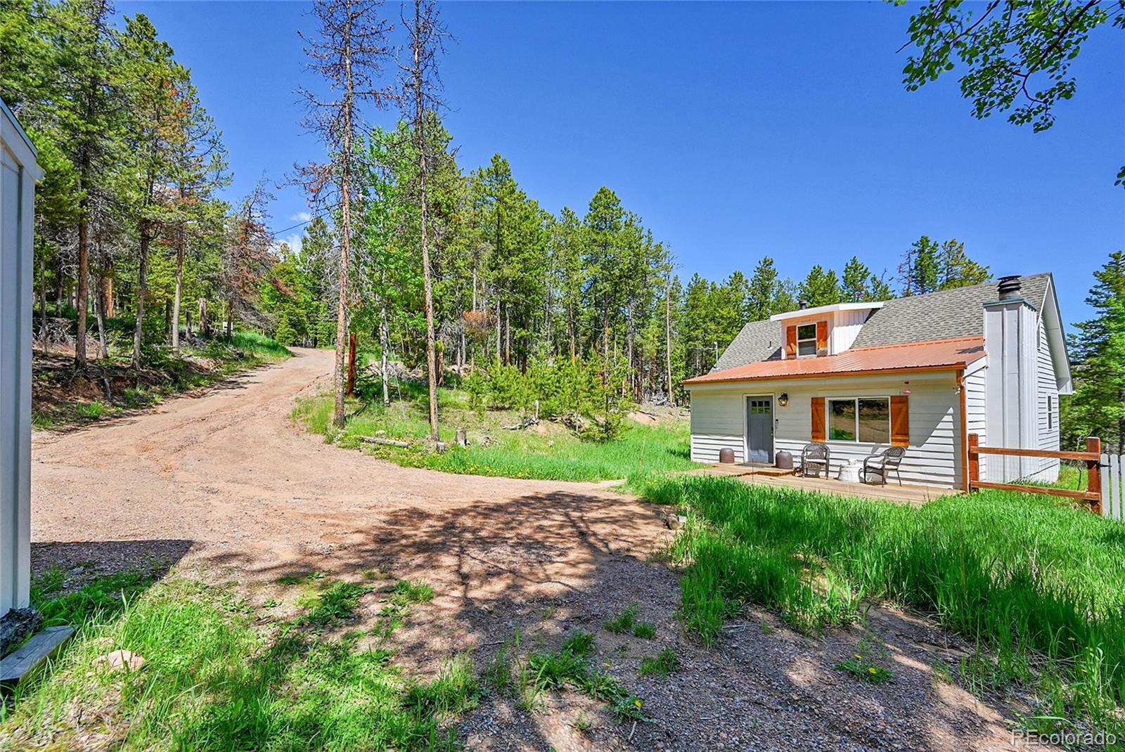 9092 South Gray Lane Conifer, CO 80433 - Photo 21 of 23 a view of a house with a big yard plants and large trees