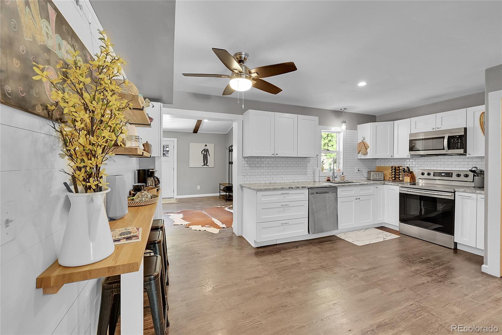 9092 South Gray Lane Conifer, CO 80433 - Photo 7 of 23 a kitchen with cabinets and fireplace