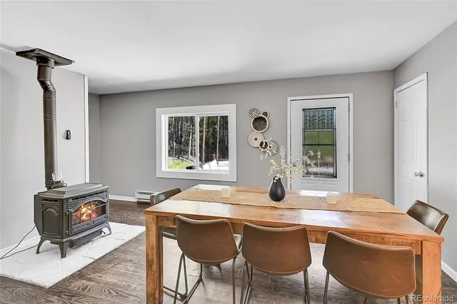 a dining room with a table and chairs