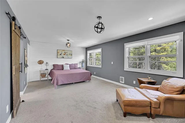 a bedroom with furniture and a window