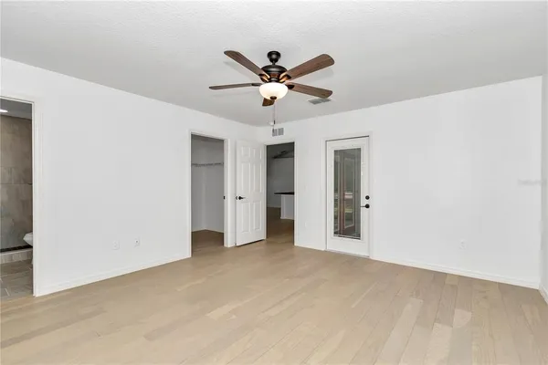 a view of an empty room with a ceiling fan
