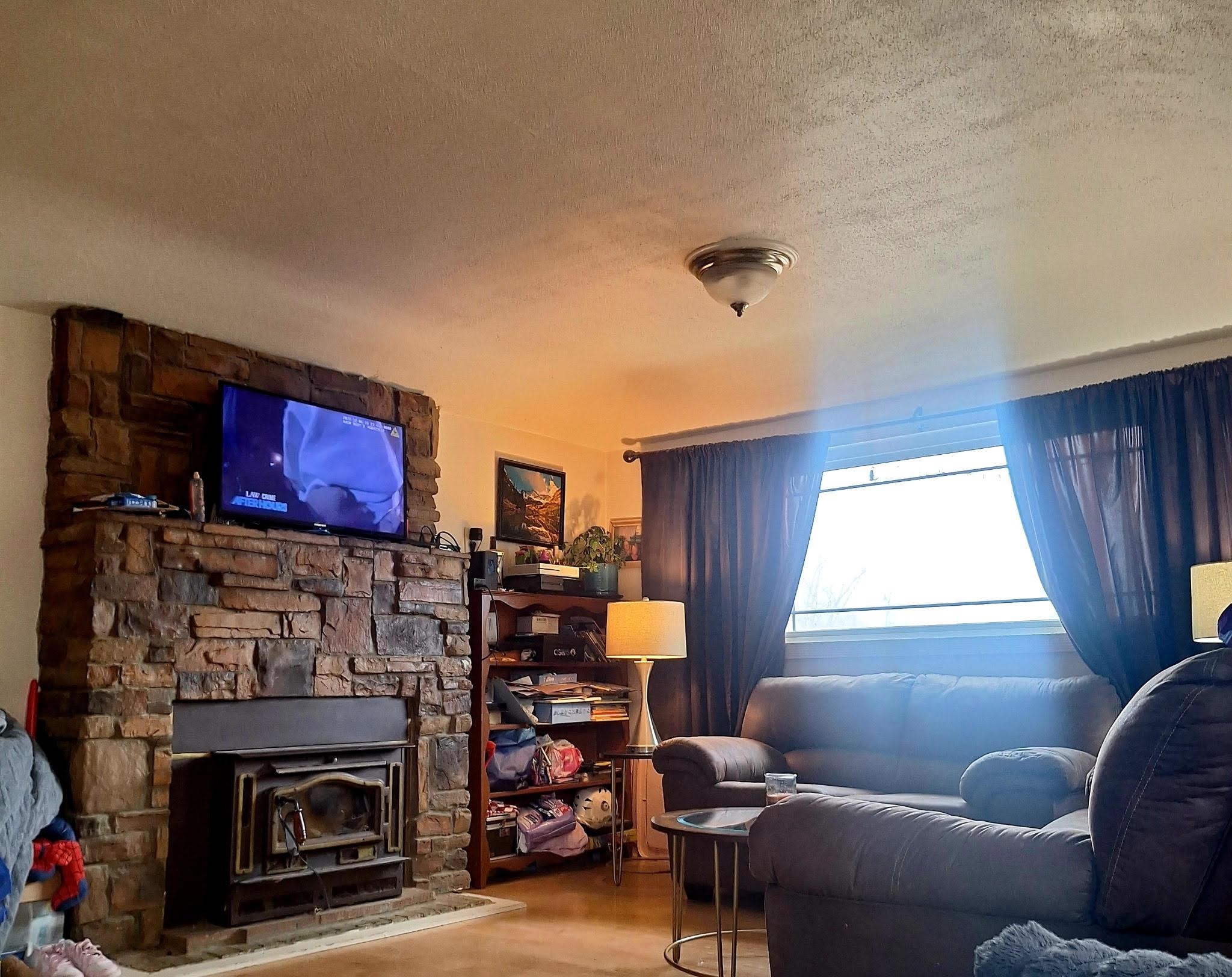 805 B Street Delta, CO 81416 - Photo 6 of 20 a living room with furniture a flat screen tv and a fireplace