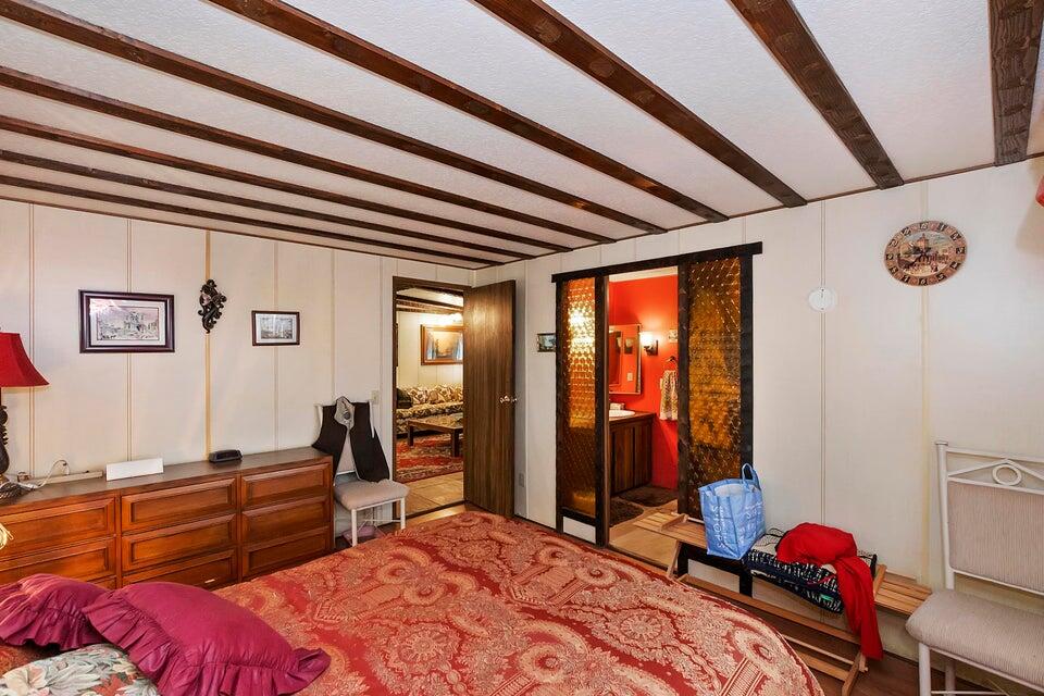 74711 Dillon Road, Unit 308 Desert Hot Springs, CA 92241 - Photo 15 of 42 a bedroom with a bed and wooden floor