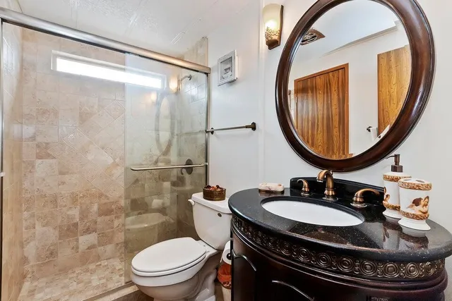 a bathroom with a toilet a sink and a mirror