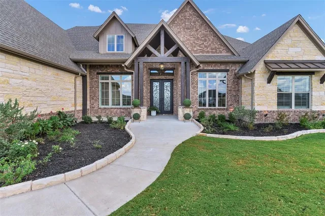 a front view of a house with garden
