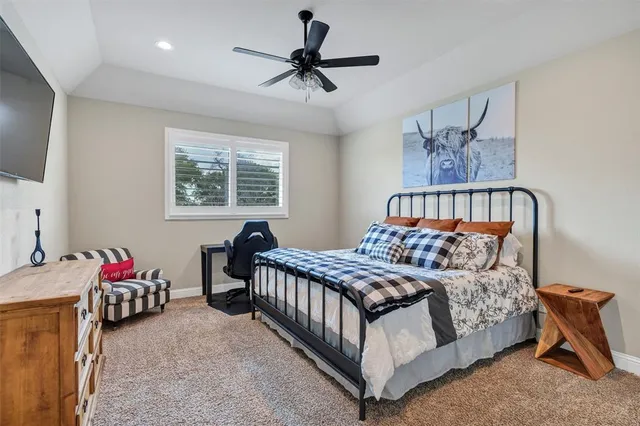 a bedroom with a bed a chandelier and a window