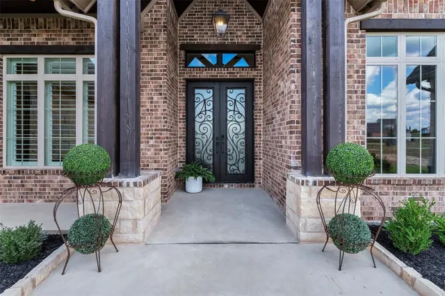a front view of a house with potted plants