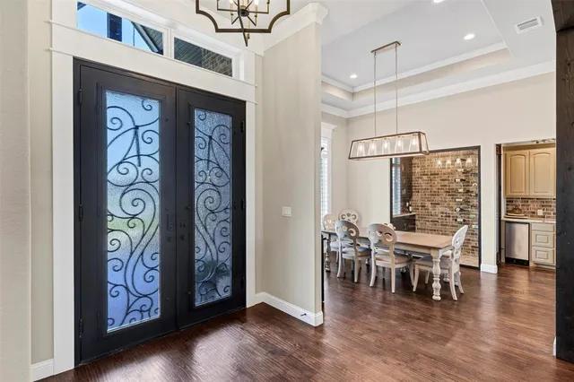 a view of a chairs and table in a room with wooden floor