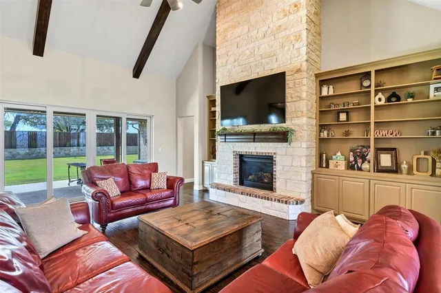 a living room with furniture fireplace and flat screen tv