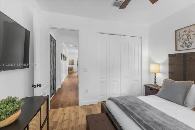 a bathroom with a toilet a sink a tub and mirror