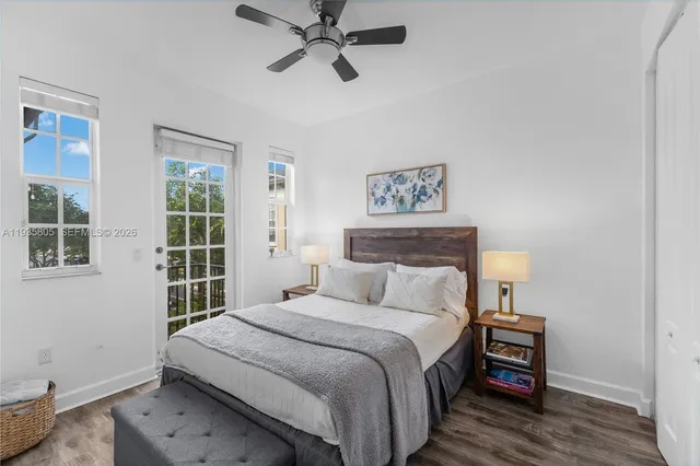 a bedroom with a bed and a painting on the wall