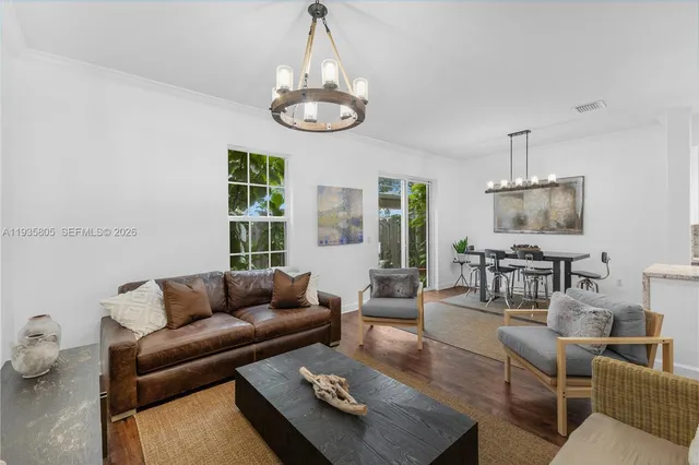 a living room with furniture wooden floor and dining table