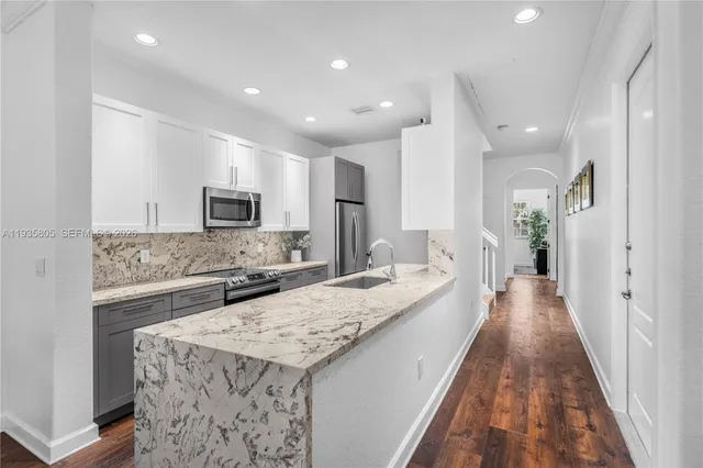 a living room with furniture a rug and a window