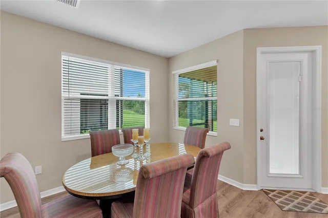 a kitchen with a sink a stove and white cabinets
