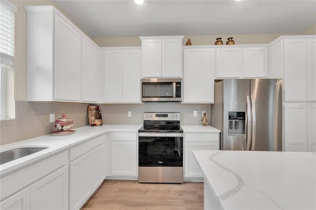 a kitchen with a sink stove and microwave