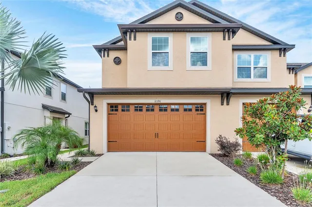 a front view of a house with a yard and garage