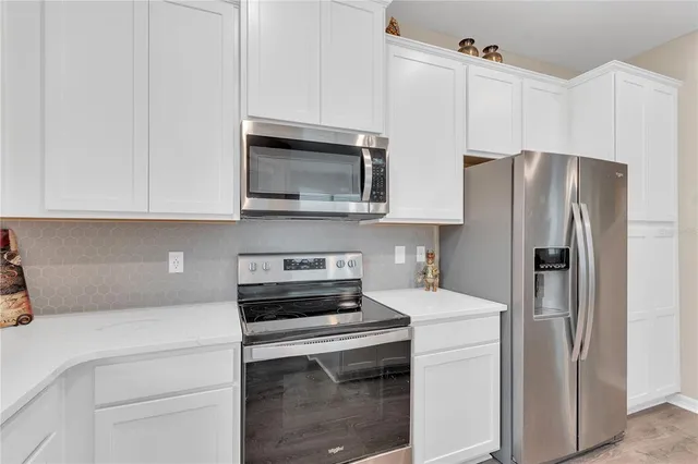a white refrigerator freezer sitting in a kitchen