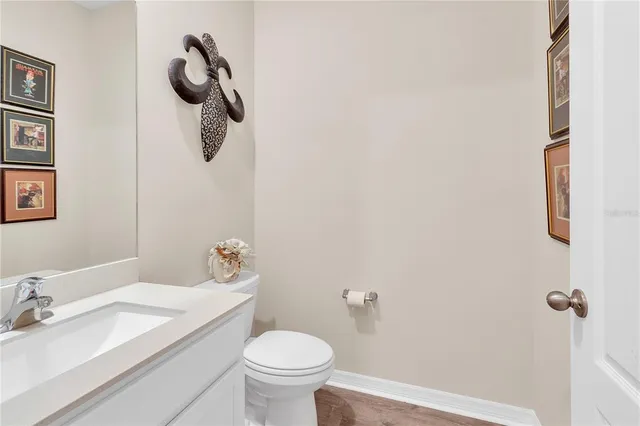 a bedroom with a bed a mirror on dresser and a chandelier