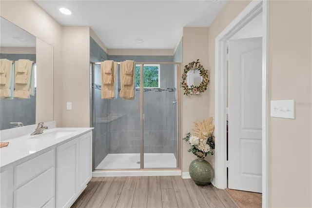 a bathroom with a double vanity sink mirror and shower