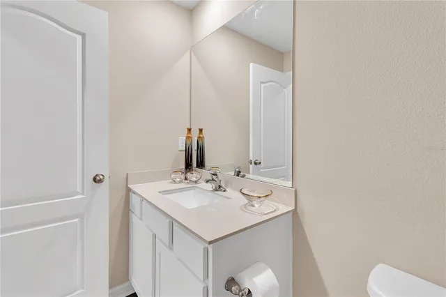a white toilet sitting next to a bathroom sink
