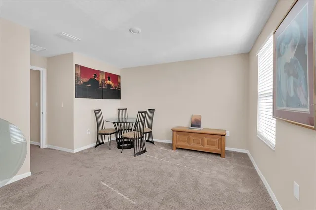 a view of an empty room with window and closet area