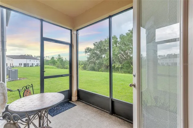 a dining room with furniture and a potted plant