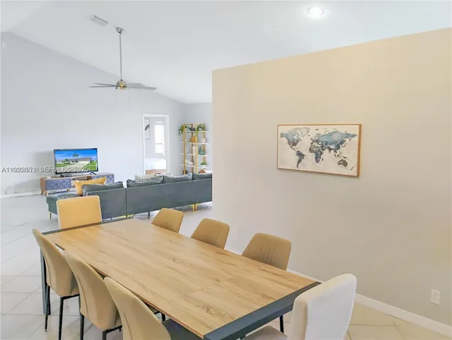 a kitchen with granite countertop white cabinets and stainless steel appliances
