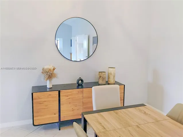 a kitchen with granite countertop white cabinets white stainless steel appliances and a sink
