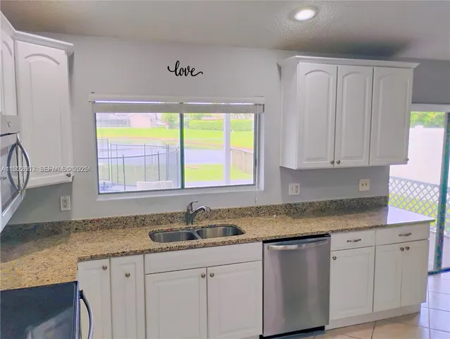 a blue couch sitting in a living room with a rug