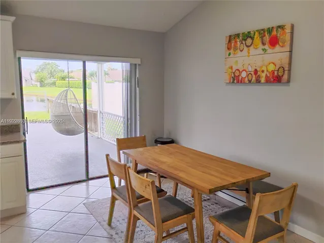 a bathroom with a granite countertop sink mirror and a bathtub