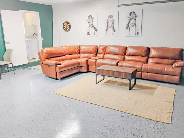 a bedroom with a bed and painting on the wall