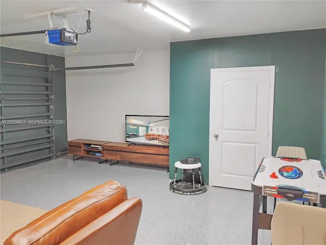 a bedroom with two bed and a chandelier