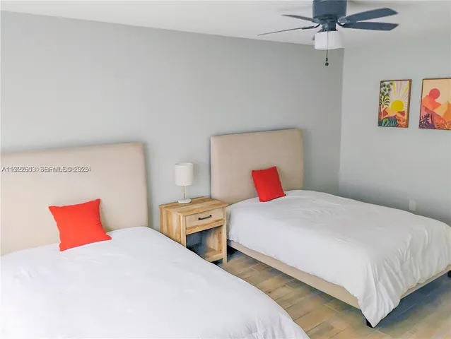 a front view of a house with a yard and potted plants