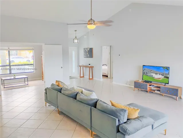 a view of kitchen with furniture and refrigerator