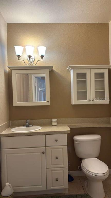 260 Old Village Center Circle, Unit 8205 St. Augustine, FL 32084 - Photo 11 of 13 a bathroom with a toilet a sink and mirror
