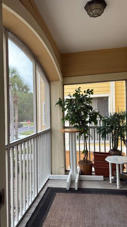 260 Old Village Center Circle, Unit 8205 St. Augustine, FL 32084 - Photo 2 of 13 a living room with furniture and a floor to ceiling window