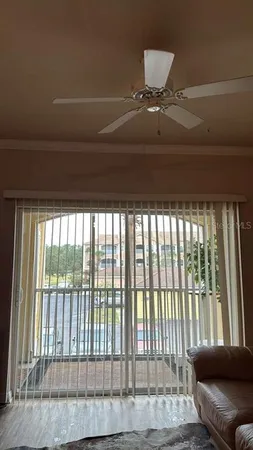 a living room with furniture and a floor to ceiling window