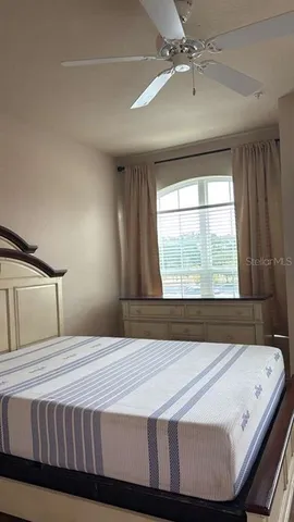 a bedroom with a large bed and a large window