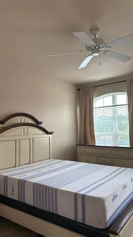 a bedroom with a bed and window