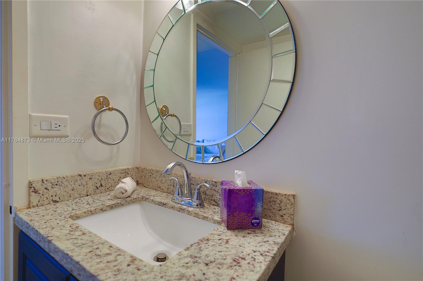 9225 Collins Avenue, Unit 503 Surfside, FL 33154 - Photo 13 of 37 a bathroom with a granite countertop sink and a mirror