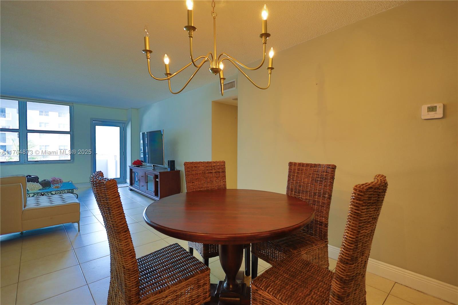 9225 Collins Avenue, Unit 503 Surfside, FL 33154 - Photo 15 of 37 a view of a dining room with furniture and wooden floor