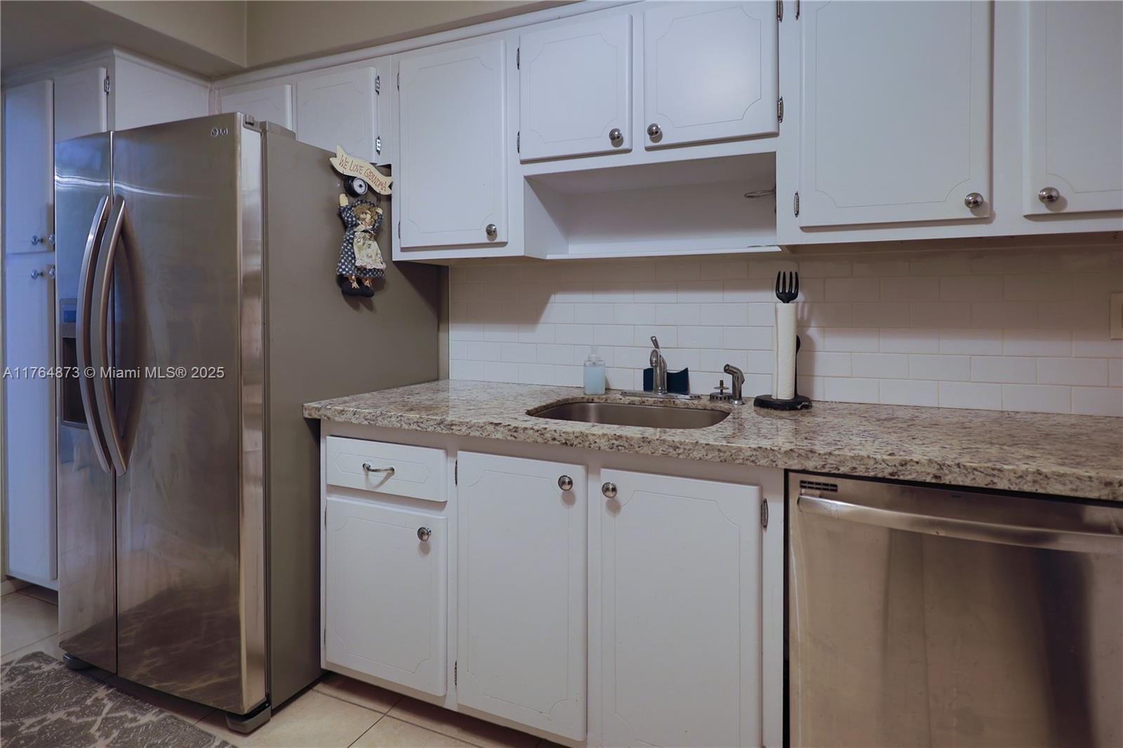 9225 Collins Avenue, Unit 503 Surfside, FL 33154 - Photo 16 of 37 a kitchen with stainless steel appliances granite countertop a refrigerator and a sink