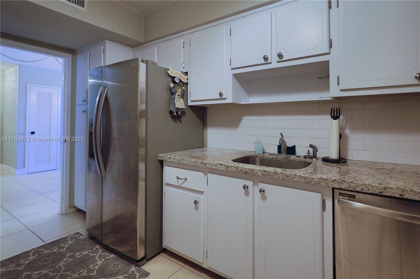 9225 Collins Avenue, Unit 503 Surfside, FL 33154 - Photo 18 of 37 a kitchen with stainless steel appliances granite countertop a refrigerator and a sink