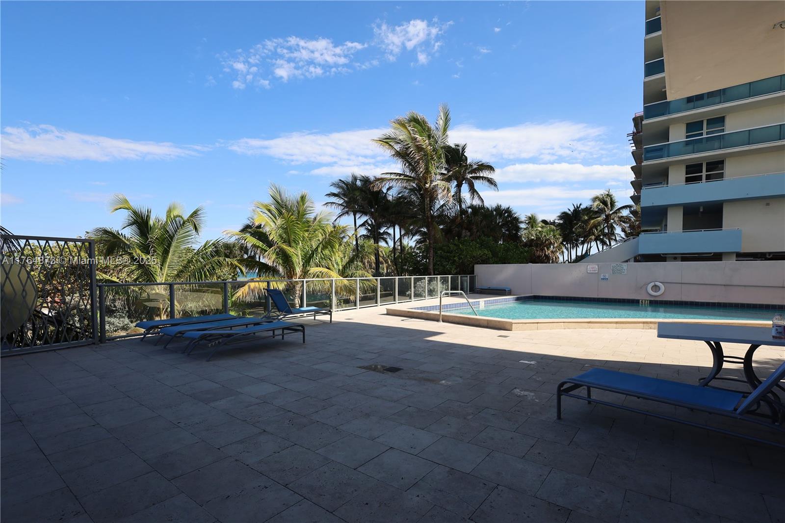 9225 Collins Avenue, Unit 503 Surfside, FL 33154 - Photo 23 of 37 a view of swimming pool with outdoor seating and plants
